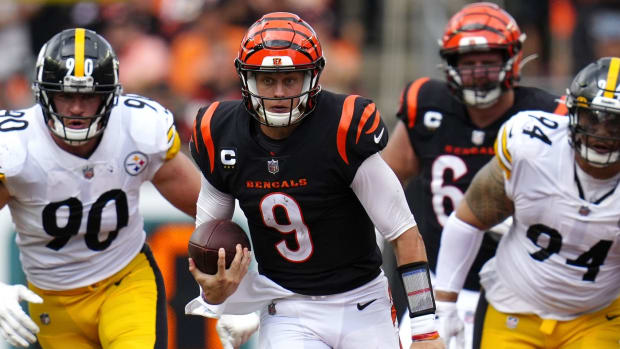 Sep 11, 2022; Cincinnati, Ohio, USA; Cincinnati Bengals quarterback Joe Burrow (9) runs for a first down during the fourth quarter of a Week 1 NFL football game against the Pittsburgh Steelers at Paycor Stadium. Mandatory Credit: Sam Greene-USA TODAY Sports